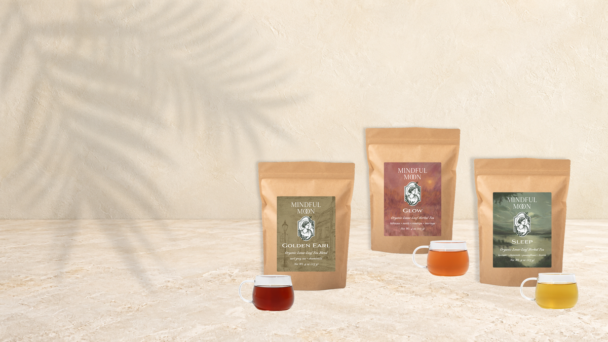 Golden Earl, Glow and Sleep tea pouches and cups on a textured stage